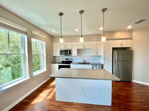 Apartment kitchen with large windows and open concept floor plan near Northwest Gainesville, FL